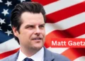 "Matt Gaetz speaking at a political event, wearing a suit and tie, representing Florida as a congressman."