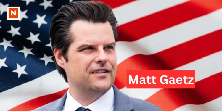 "Matt Gaetz speaking at a political event, wearing a suit and tie, representing Florida as a congressman."